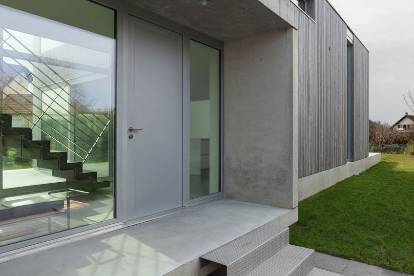 Entrance of a modern house in concrete and wood, outside